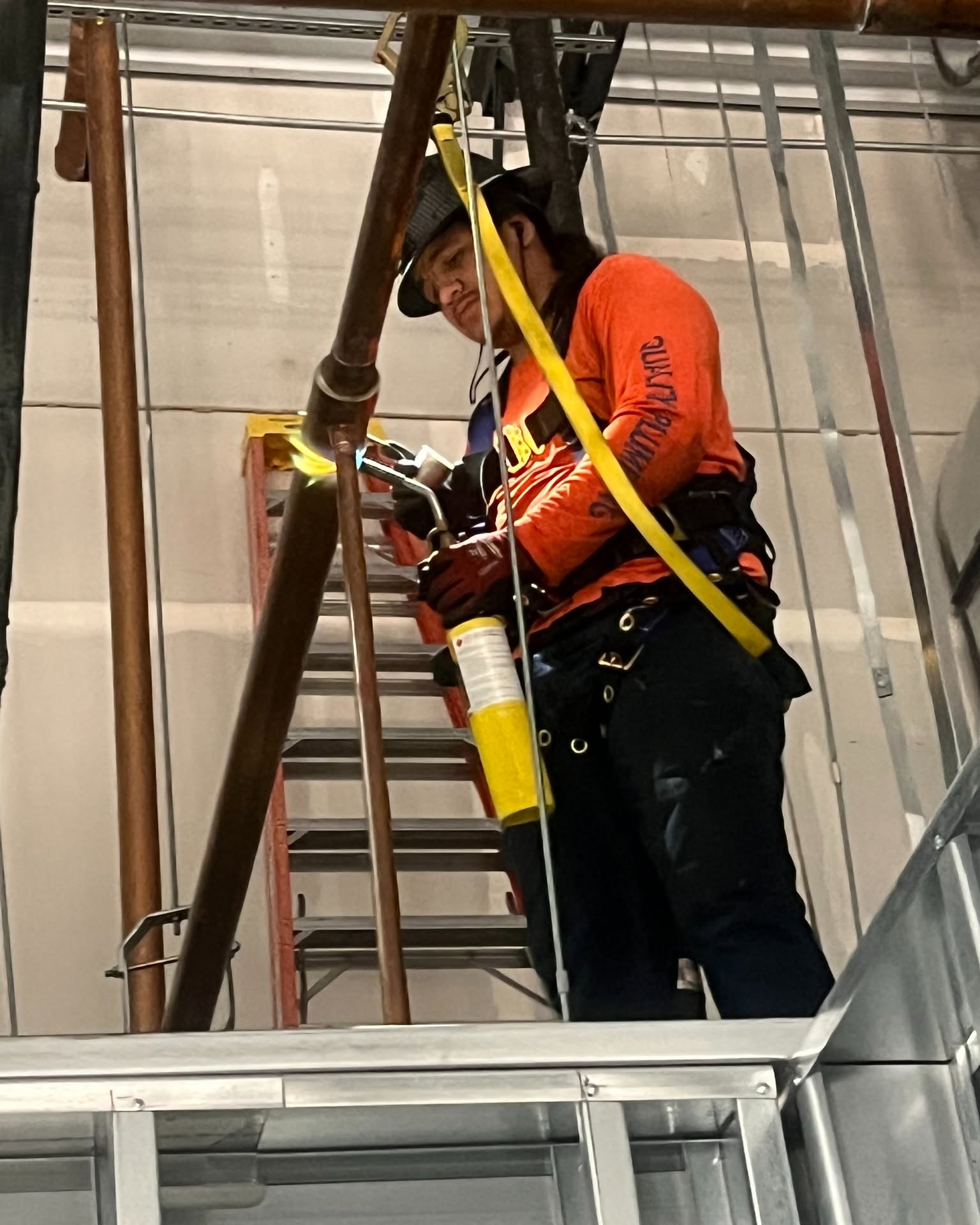 Holman's Quality Plumbing technician installing plumbing in new construction