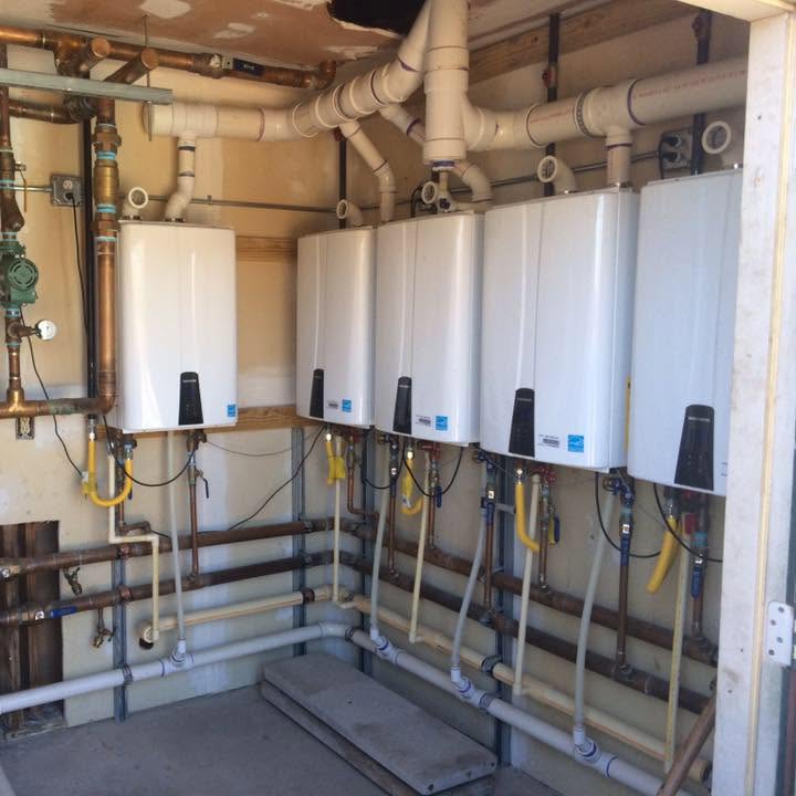 Bank of tankless water heaters installed by HQP